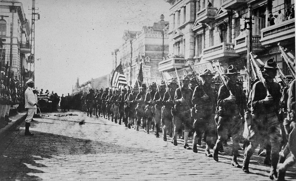 Soldados estadounidenses recorriendo las calles del puerto de Vladivostok, en agosto de 1918. Este contingente formó parte de una fuerza multinacional que apoyó al Movimiento Blanco.